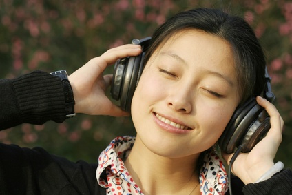 Asian businesswoman listening music
